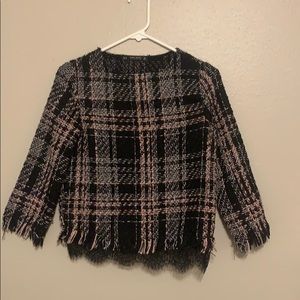 a squared pink and white and black shirt.